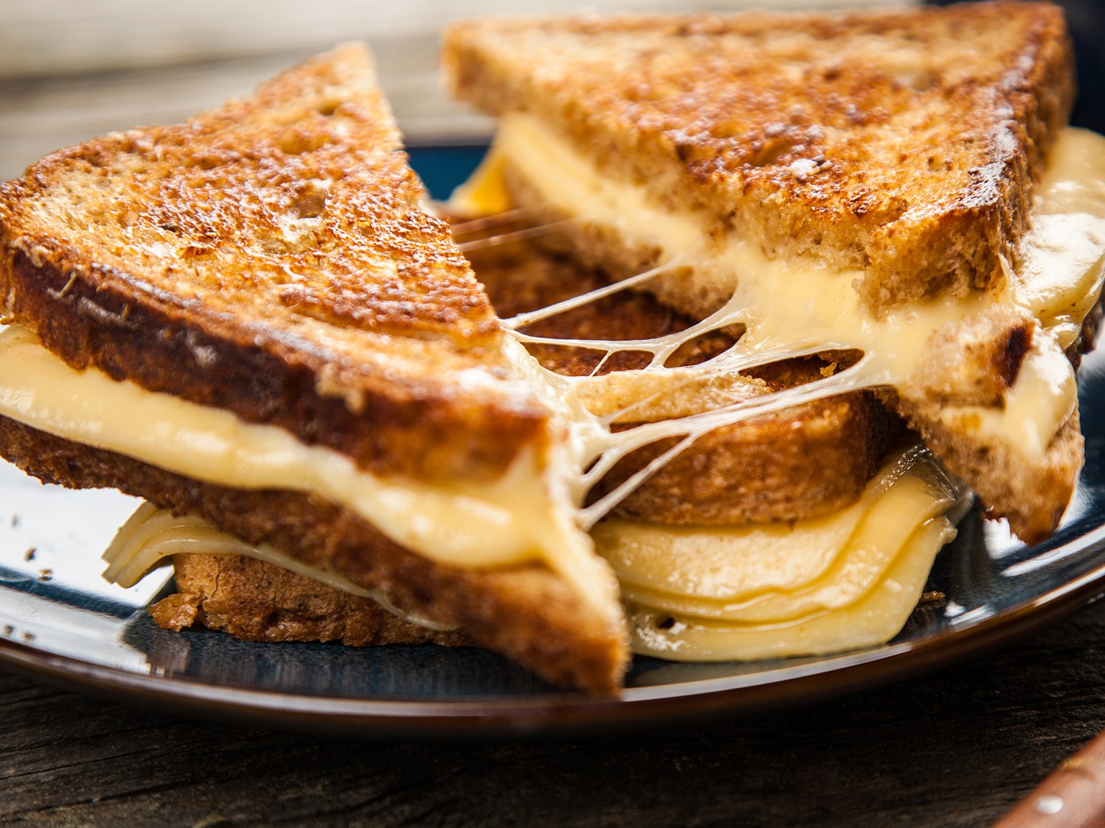 Four cheeses, low heat, and patience. The mayo is the secret to the perfect crust. Have you tried a grilled cheese with mayo on the OUTSIDE? Life-changing.