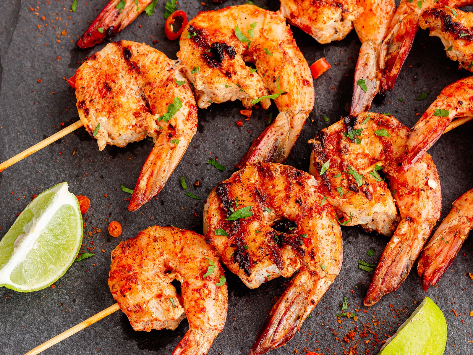 Jumbo shrimp marinated in a fiery peri-peri sauce made from African bird's eye chiles, garlic, lemon, and smoked paprika. Grilled on skewers until charred and served with a cooling coconut yogurt dip.