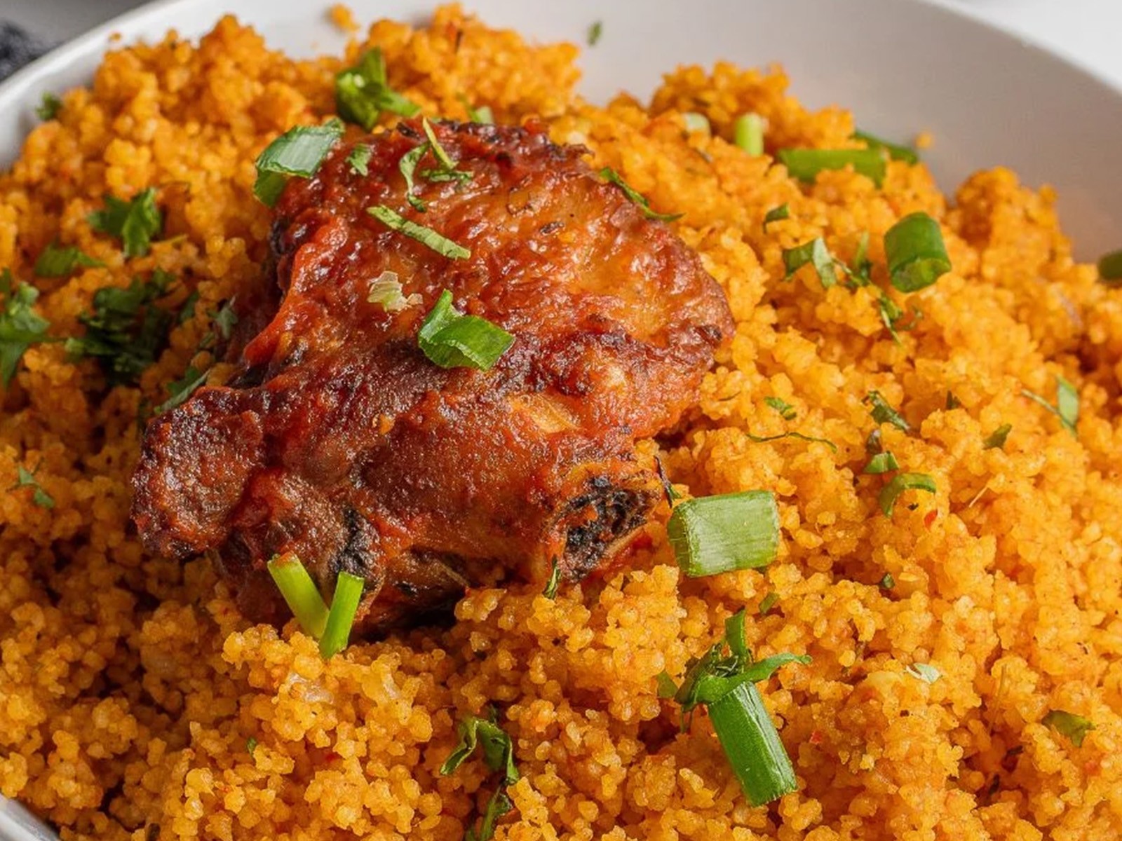 West African jollof flavors — tomatoes, scotch bonnet, onion, and warm spices — applied to quick-cooking couscous instead of rice. All the smoky depth in a fraction of the time.