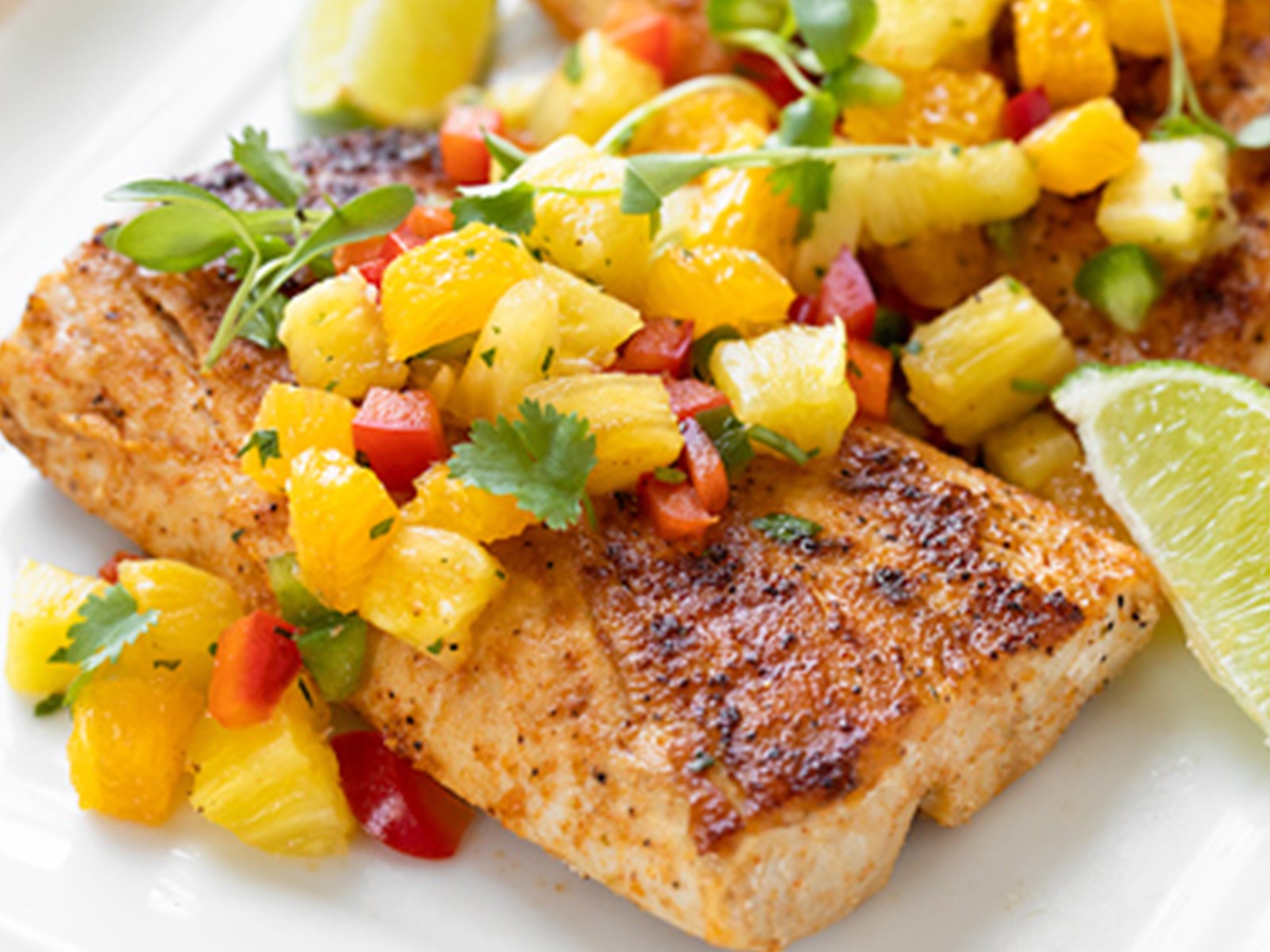 Mahi-mahi fillets glazed in a sweet-heat mango-habanero reduction and seared until caramelized. Served over coconut rice with a papaya slaw. The glaze is the star — fruity, fiery, and completely addictive.