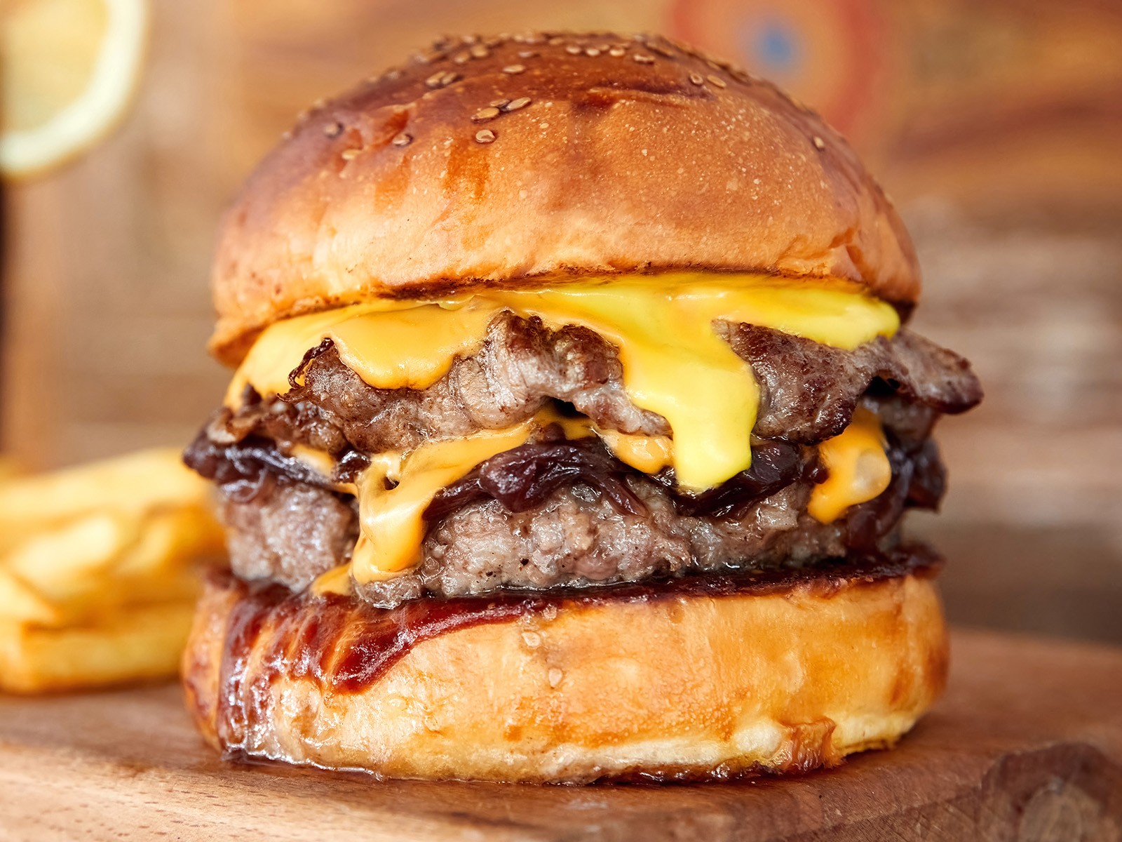A smash burger the way it’s meant to be. Fresh-ground chuck and brisket, pressed thin on a blazing hot griddle until the edges crisp and caramelize. American cheese melted just right, stacked with pickles and a house sauce, all on a soft brioche bun. Simple. Done right.