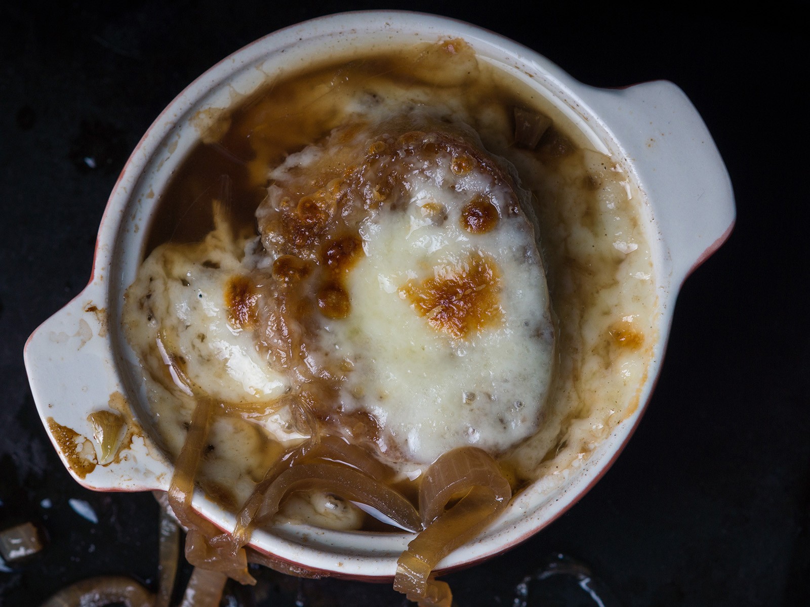 Three pounds of onions caramelized for two hours until deep brown and sweet. A rich beef broth, a crusty crouton, and a mountain of melted gruyère broiled until bubbling. This one takes commitment.