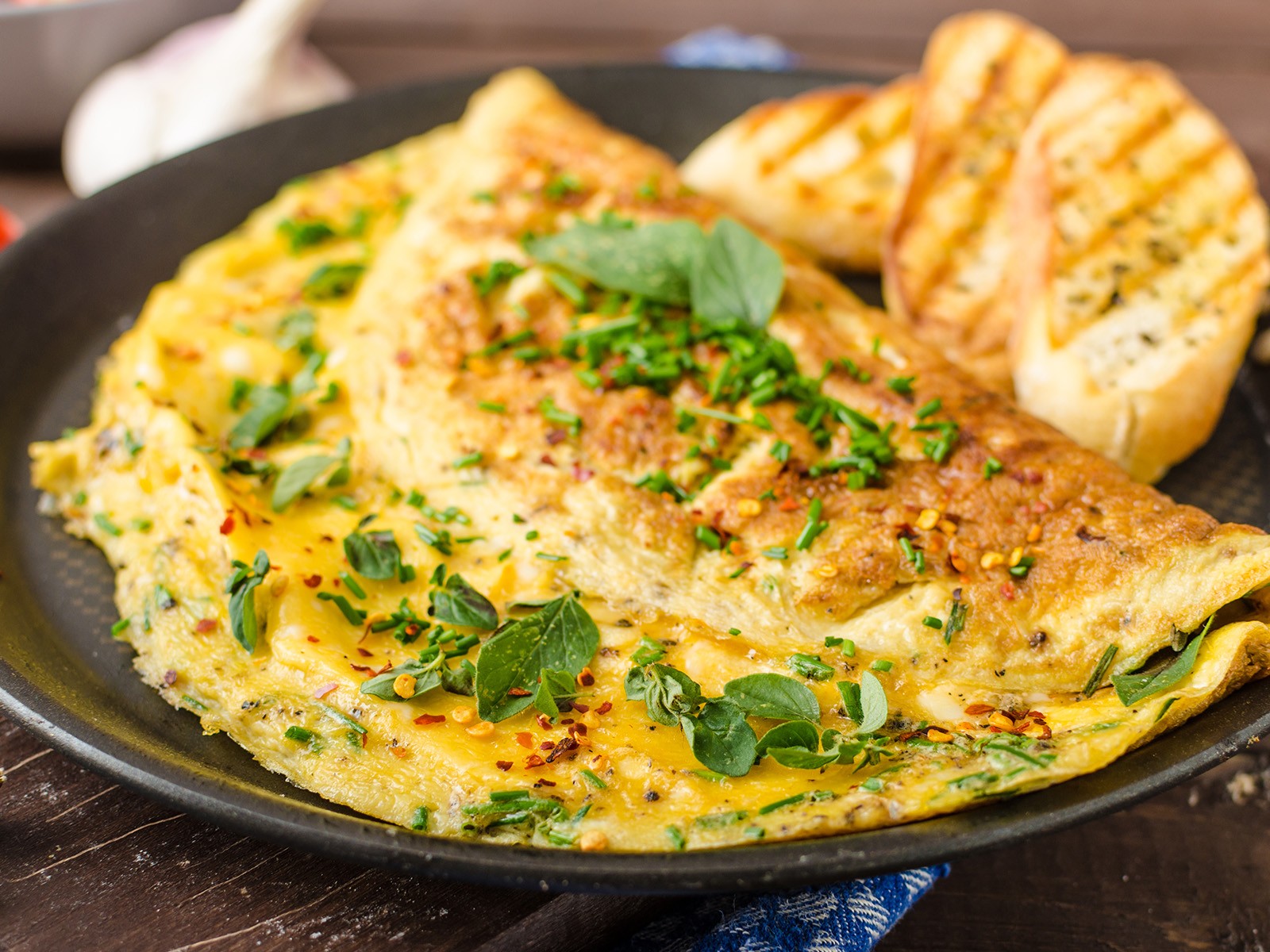 A perfect French-style omelet is a skill. Pale yellow outside, no color, soft and custardy inside, filled with melted gruyère, cheddar, and parmesan. Worth mastering.