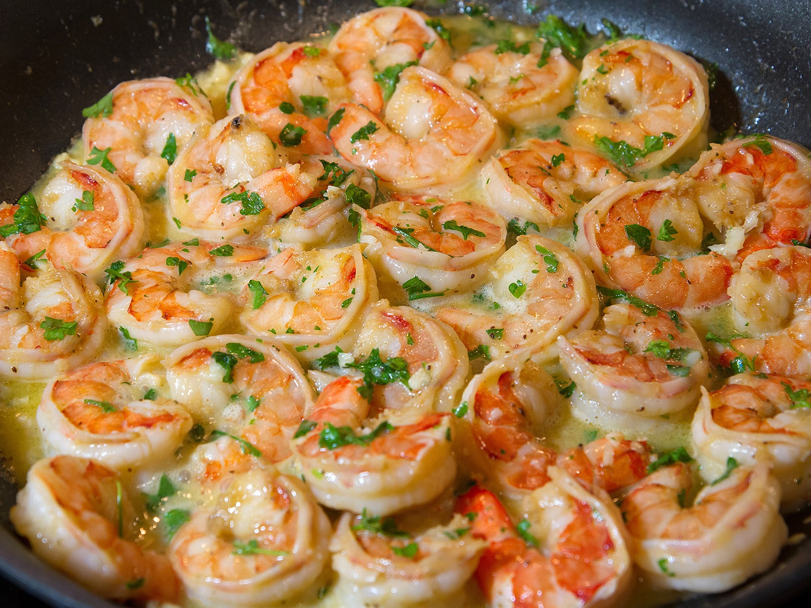 Jumbo shrimp cooked in a garlicky white wine and butter sauce that pools at the bottom of the plate and demands to be sopped up with crusty bread. Fast, impressive, and endlessly satisfying.