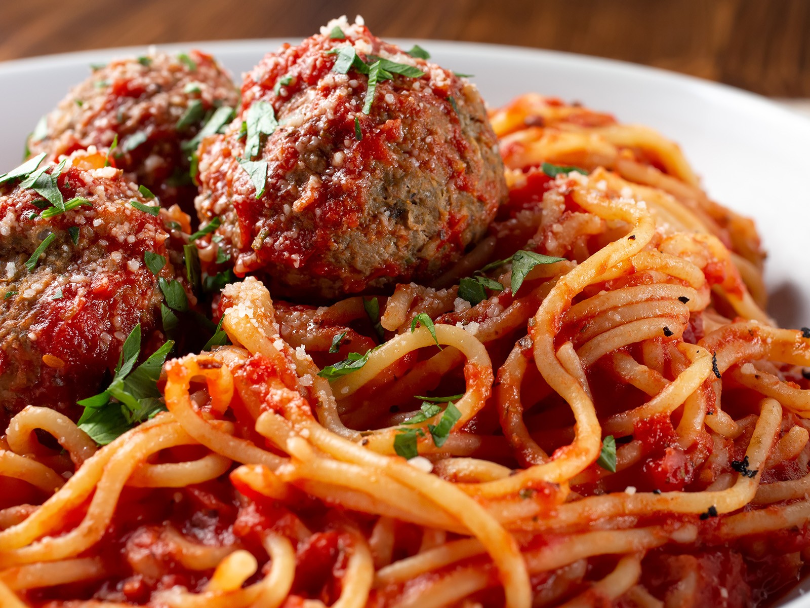 Pork and beef meatballs braised in a slow-cooked Sunday sauce for three hours until they are tender all the way through and the sauce is thick and deeply red. This is the only version I make.