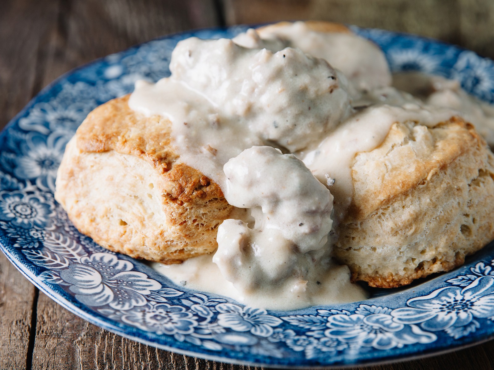 Southern comfort at its finest. Flaky buttermilk biscuits smothered in a rich, peppery sausage gravy. This is the kind of breakfast that makes people drive long distances.