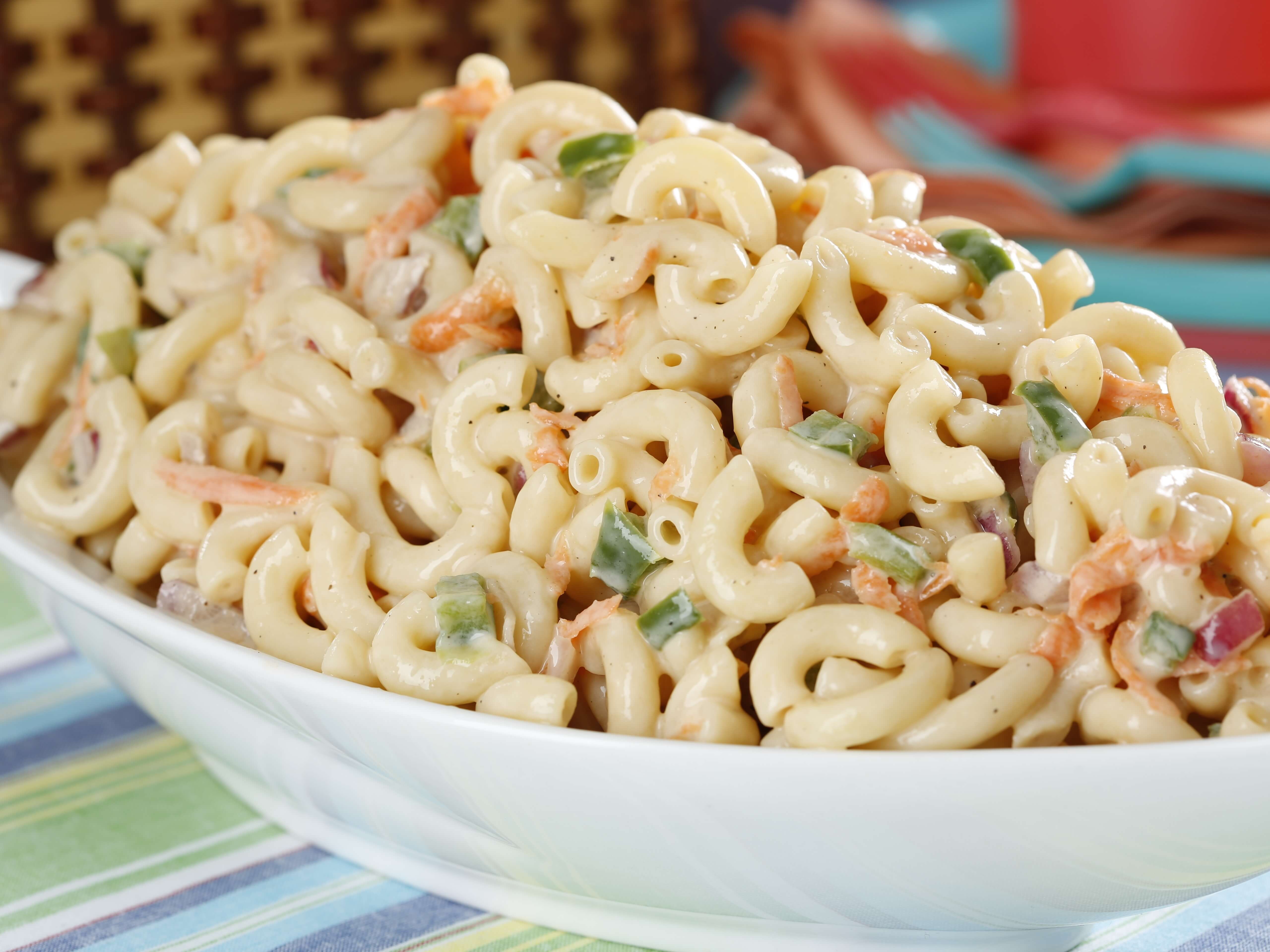 Elbow macaroni in a creamy dressing with celery, red onion, hard-boiled eggs, and sweet pickles. Cold, tangy, and essential at any cookout. Tastes even better the next day!