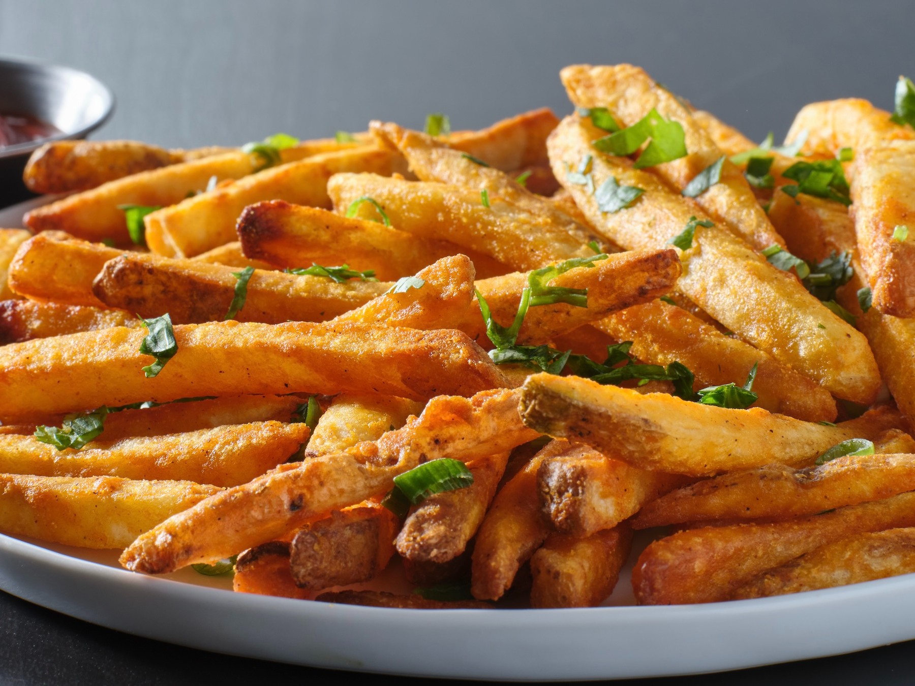 Russet potatoes cut thick, soaked in water, twice-fried — first at 300°F to cook through, then at 375°F to develop the crust. Salted the moment they come out. Everything else is up to you.