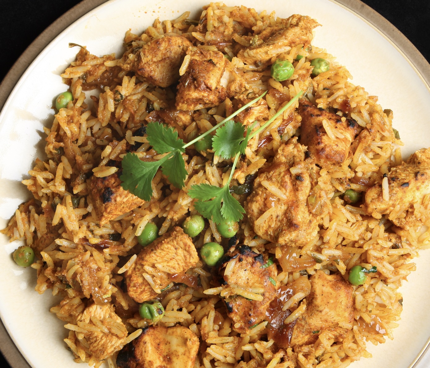 Fragrant rice layered with spiced chicken and herbs. Aromatic, bold, and a true centerpiece dish.