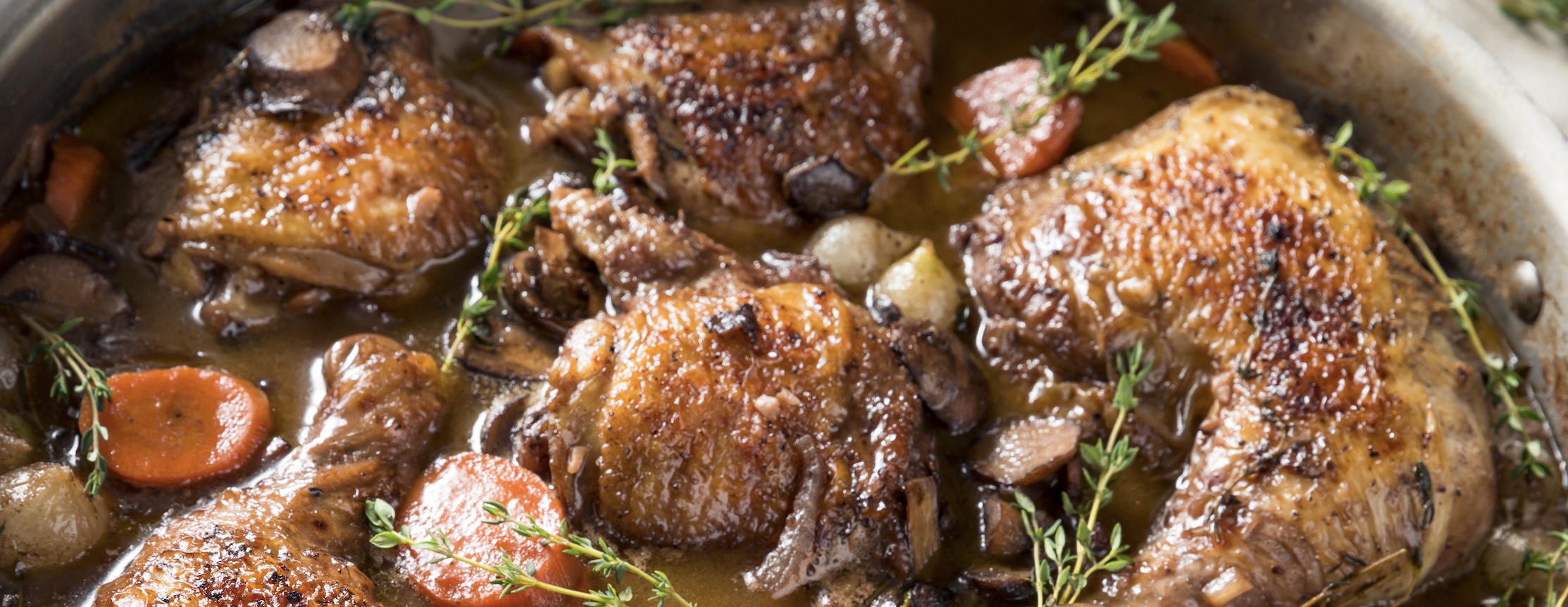 Chicken braised in red wine with mushrooms and herbs. Deep, rich, and classic French comfort food.