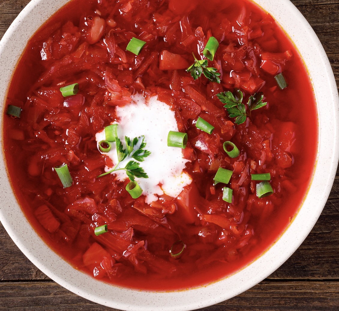 Bright beet soup with cabbage and herbs. Earthy, slightly sweet, and finished with sour cream.
