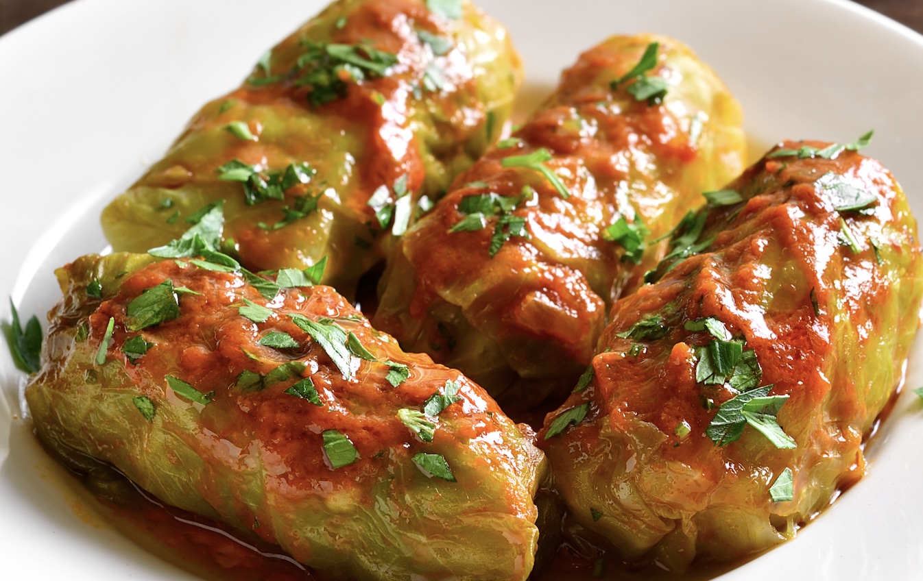 Cabbage leaves stuffed with meat and rice, simmered in tomato sauce. Hearty and full of flavor. This is the Romanian version but growing up with an Irish mother, I know the recipe doesn't differ between the two countries.
