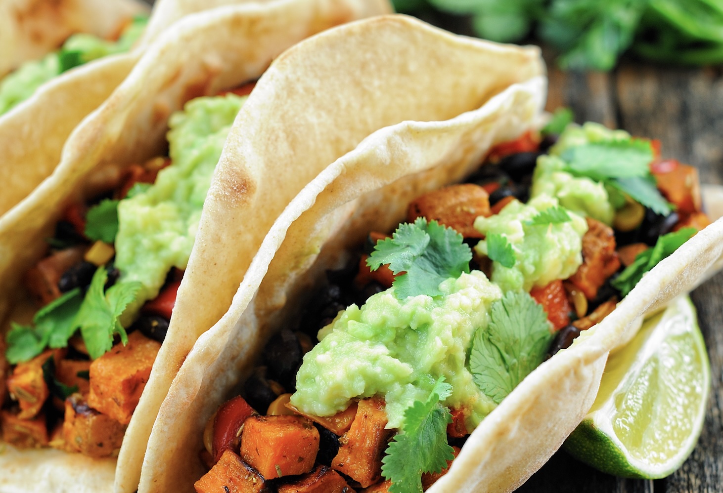 Smoky and satisfying. Roasted sweet potatoes, seasoned black beans, and zesty lime slaw in charred tortillas. Perfect for taco night.