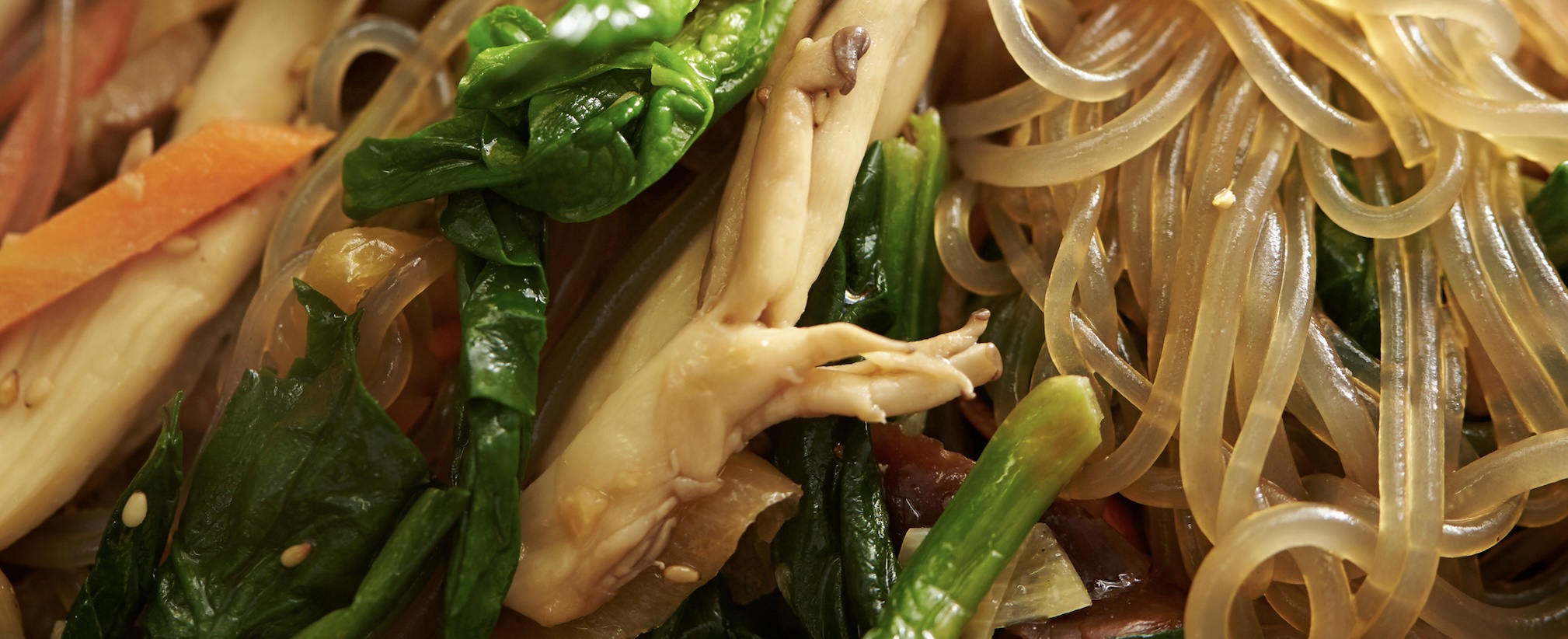 Chewy glass noodles stir-fried with colorful vegetables and savory soy sauce. A sweet and savory festive dish.