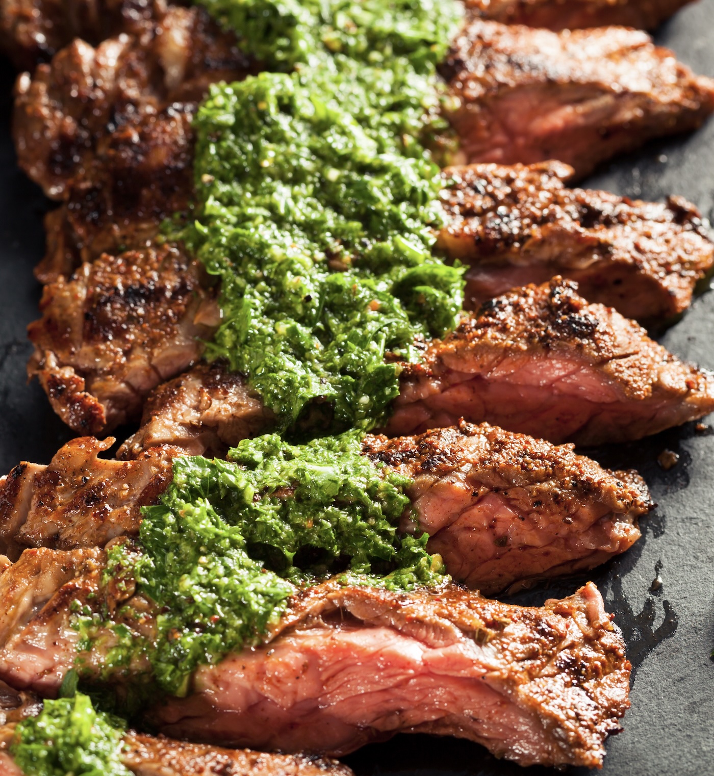 Grilled steak with a tangy, herbaceous green sauce. Bold flavors that melt in your mouth.  Once you perfect a chimichuri like this you'll put it on everything.