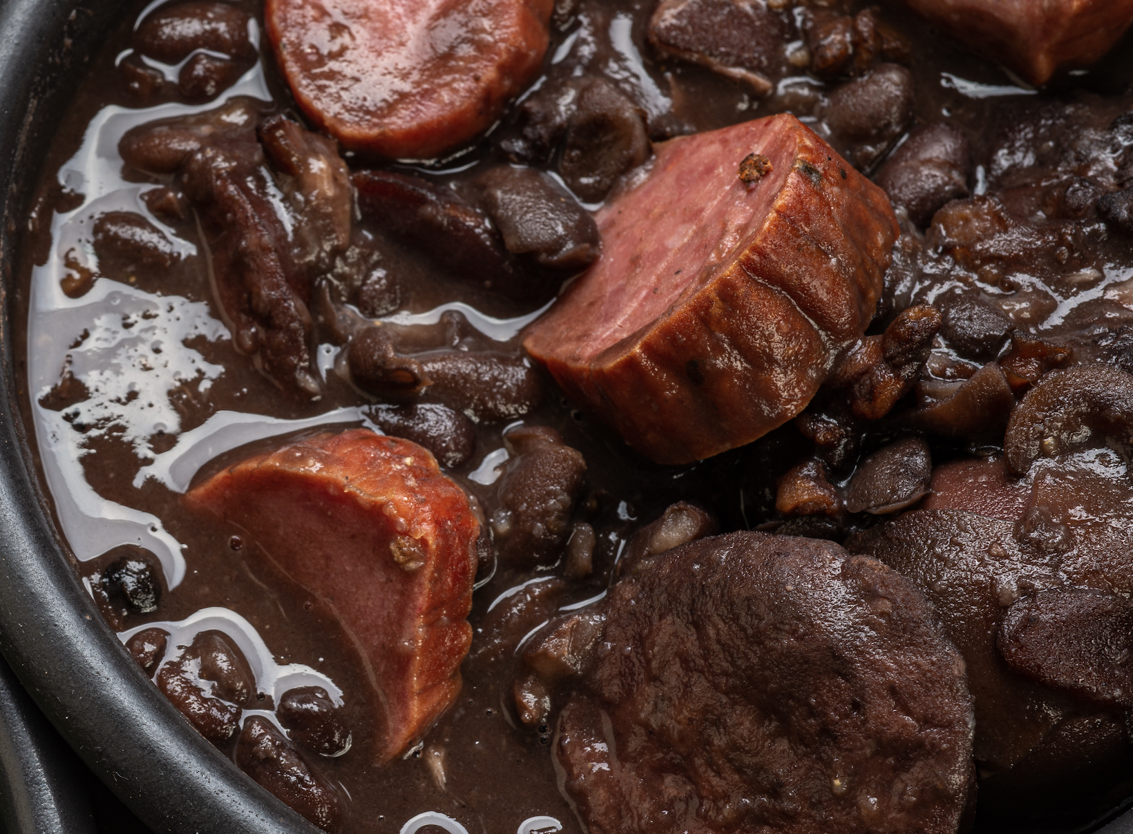 A rich, hearty black bean stew with smoky pork. Comfort food defined, best served over rice. Tradition says serve with orange slices.